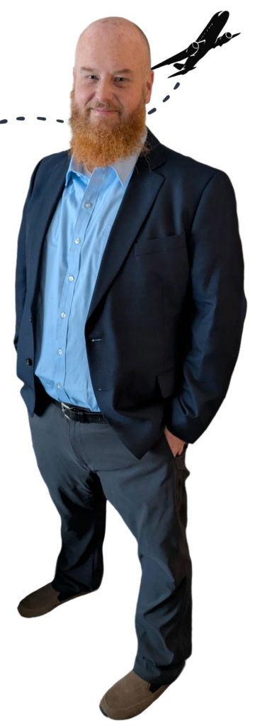 Scott Dills standing in nice dress attire with a cartoon airplane flying behind his head.